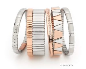 Photo of six magnetic bracelets stacked next to each other horizontally. 