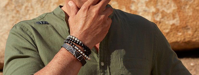 Male model wearing a selection of magnetic bracelets and magnet strip 