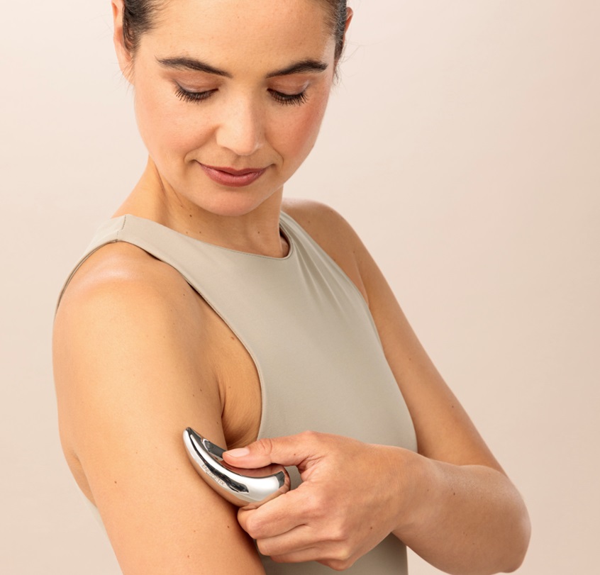 A model using the ENERGETIX Magnet Massage on her arm