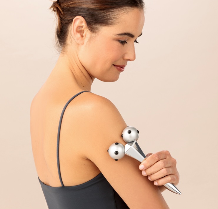 A model using the Magnet Body Roller on the top of her arm