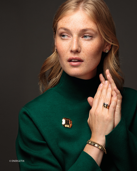 A lady in green wearing a MagnetLuck cloverleaf body magnet with copper counterpart